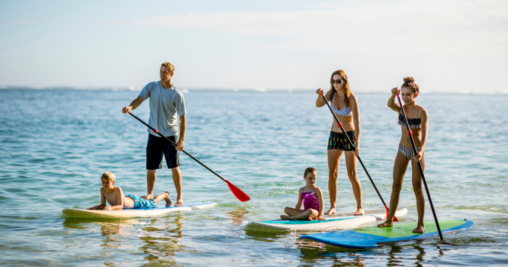 A family paddleboarding along the sound on the Outer Banks